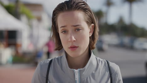 portrait of beauitful young woman looking worried sad on warm vibrant beachfront background