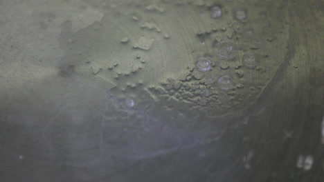 in a close-up perspective, water is being poured into a hot pan, highlighting the fundamental aspects of the cooking process