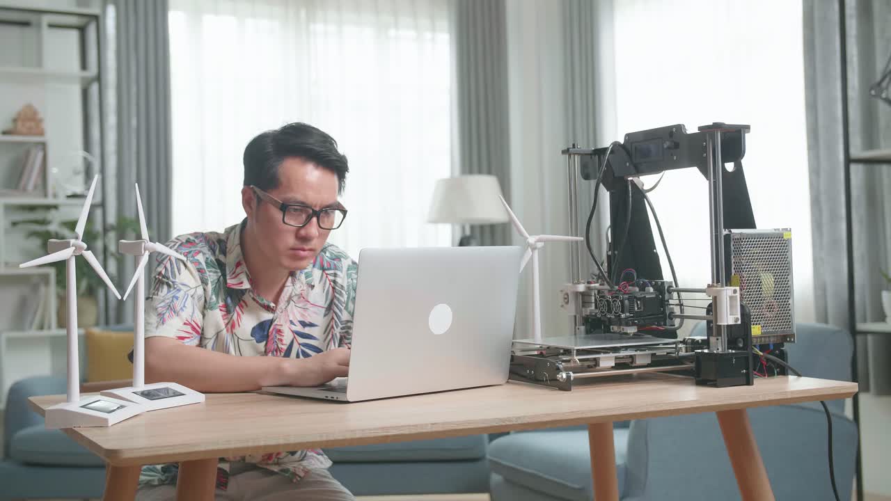 Man working on a 3D printer at home