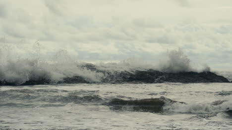 stormy seascape with waves crashing on rocks