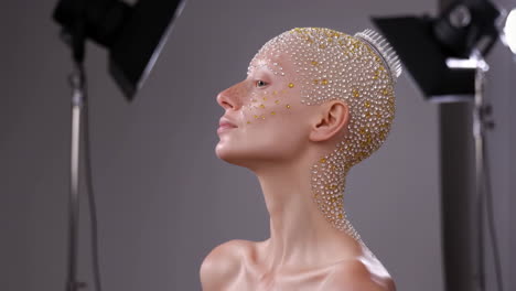 model with ornate gemstone body art and headpiece in studio