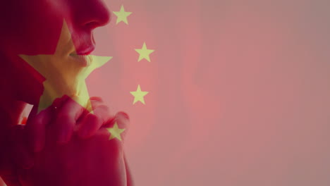 chinese flag animation overlay on silhouette of person with contemplative expression