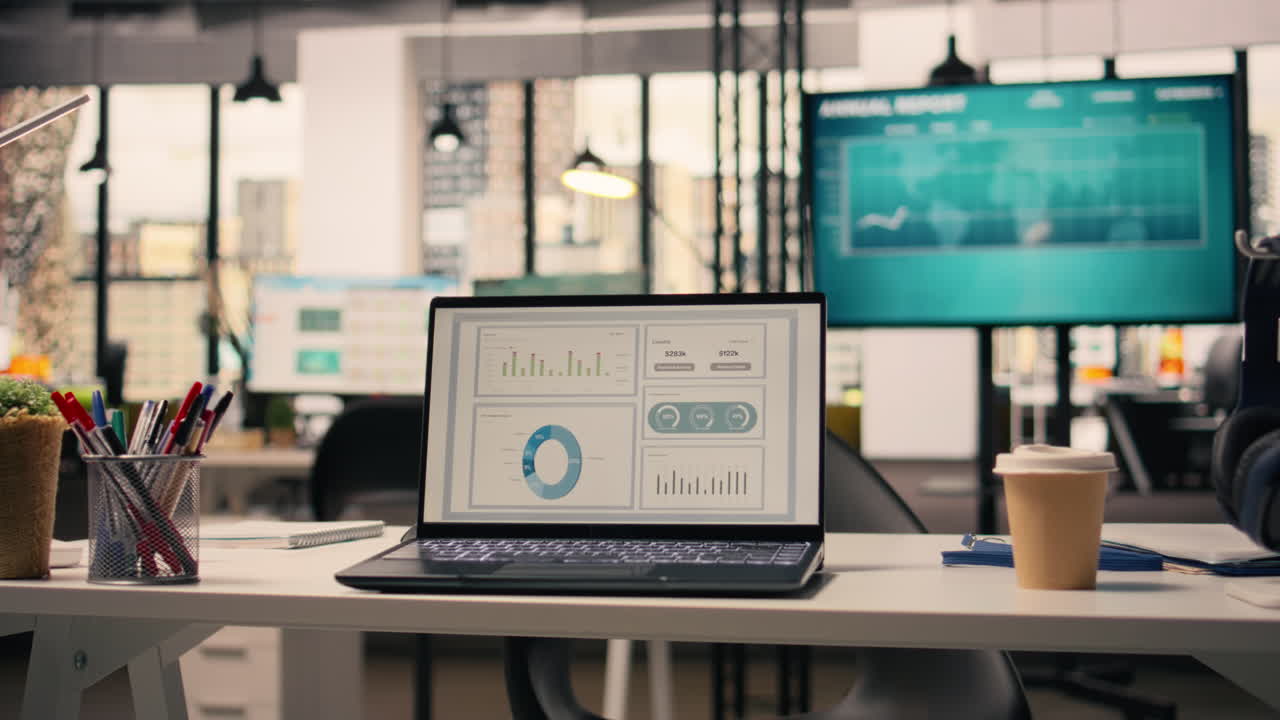 Company data shown on screen in empty executive office space