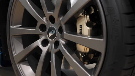 close-up of a car wheel, tire, and brake caliper