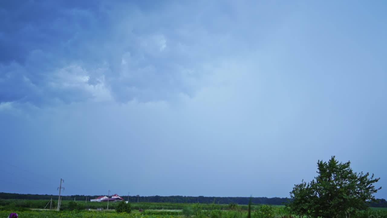 Real flashes of lightning on the blue sky background. The blue sky changes its color into orange after the bright lightning.