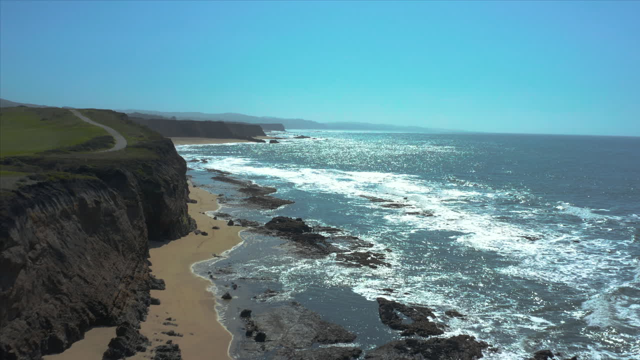 Aerial Drone sliding shot of the cliffs overlooking the crushing waves at Half Moon. Bay, California, USA