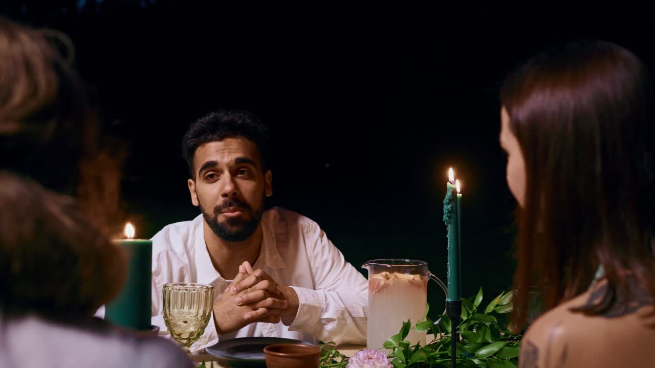 People having a dinner party with candles