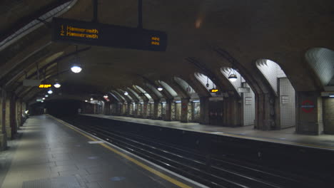 empty hammersmith line tube station platform at night