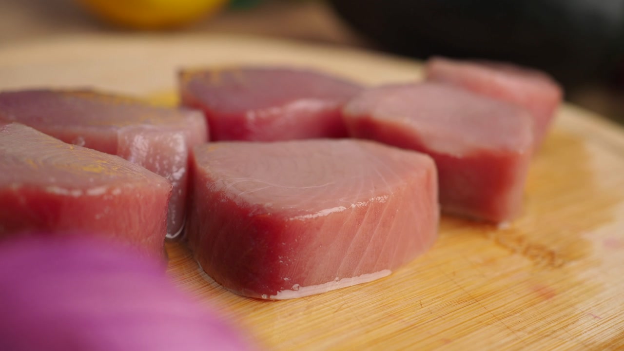 Close-up of Fresh Raw Tuna Steaks on a Wooden Cutting Board