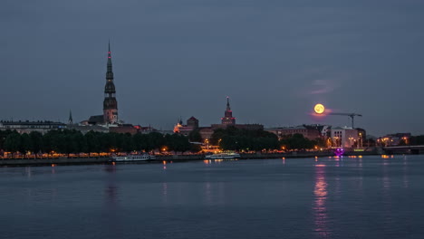 historic centre of riga in latvia in view from the daugava river at moonrise in timelapse