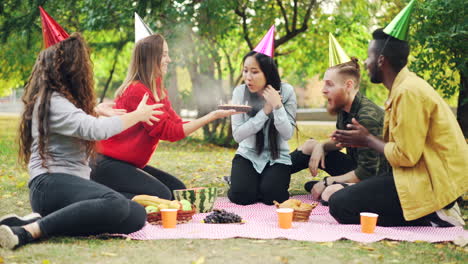 friends celebrating a birthday picnic in the park