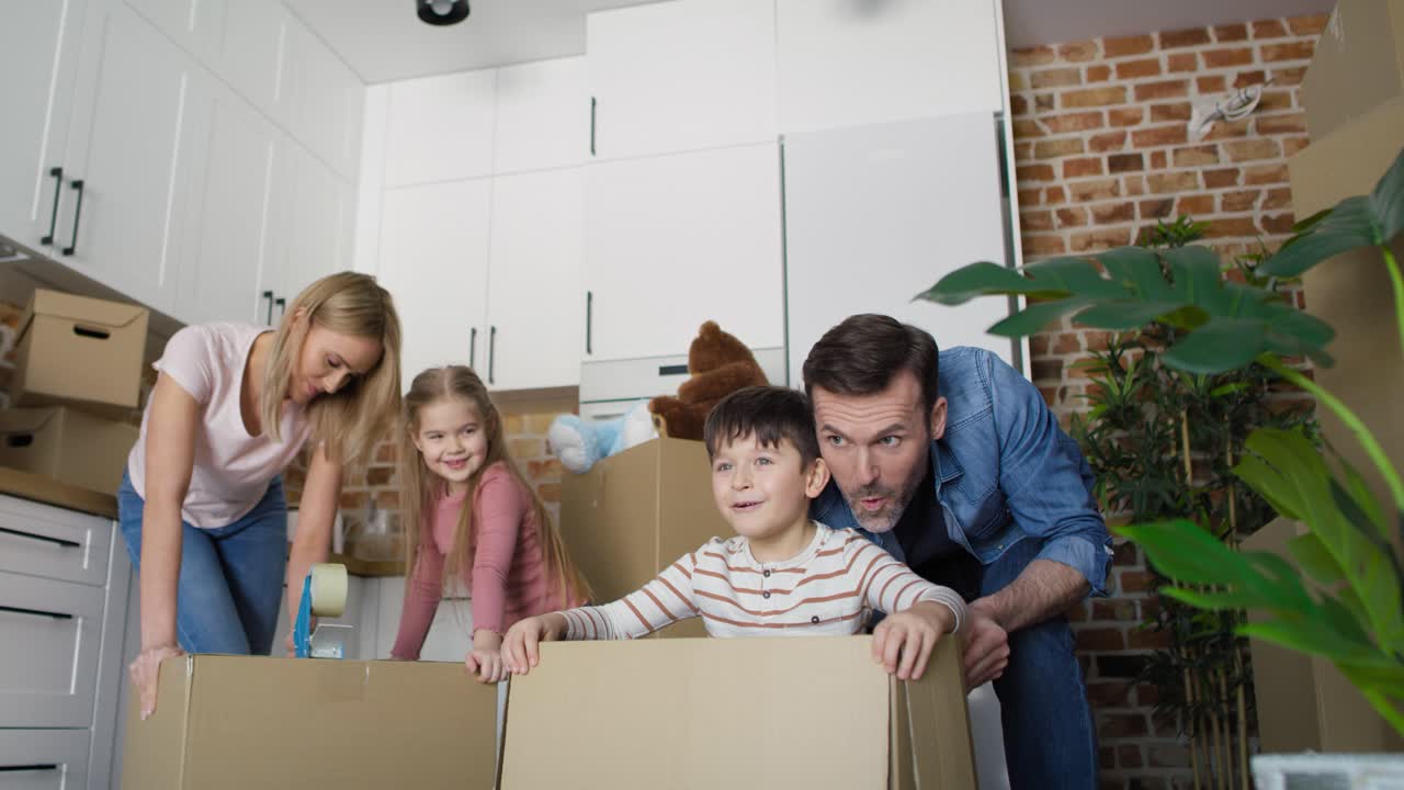 Video of son and father have fun during moving home