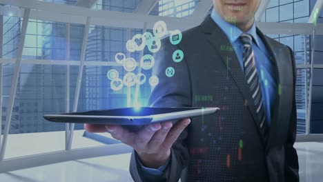 animation of digital icons over businessman holding tablet