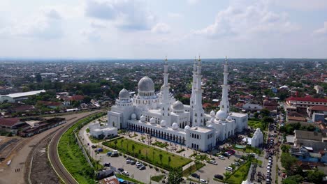 Aerial-panorama-view-of-SHEIKH-ZAYED-GRAND-MOSQUE-with-city-of-solo-in-background---Indonesia,-asia