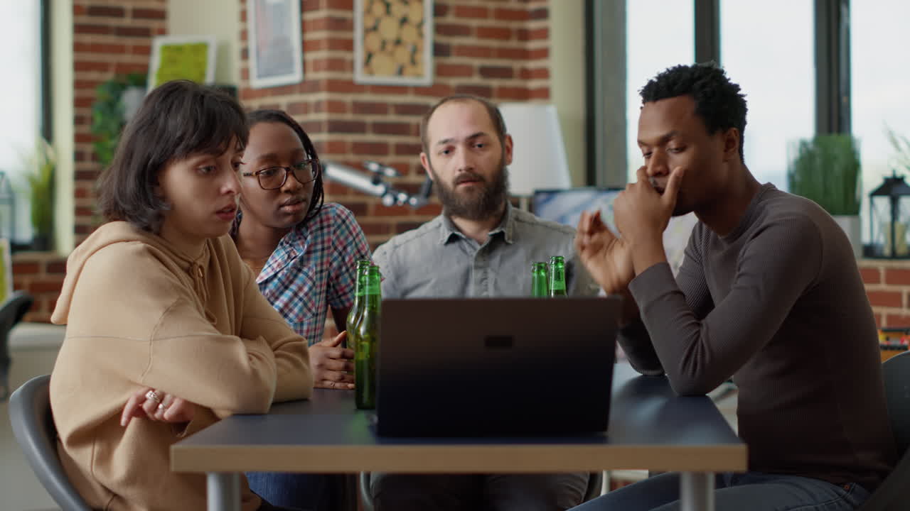 Millennial people watching online video on laptop together
