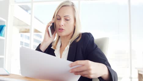 businesswoman talking on the mobile phone at her desk