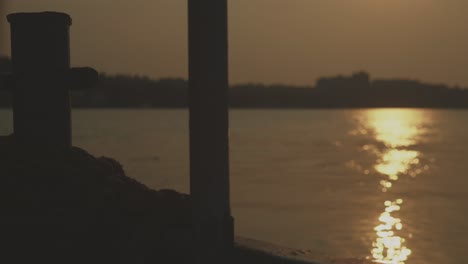 Sun-Reflecting-on-the-Water,-View-From-a-Sailing-Boat-in-India,-Slow-Motion,-POV