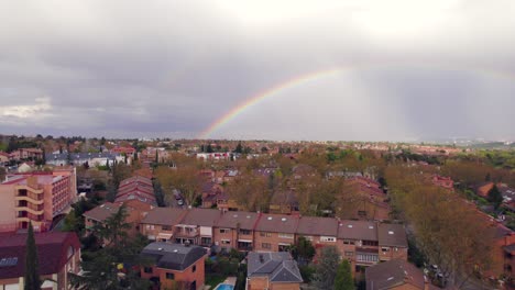 colorful rainbow in the sky over residential spanish neighborhood