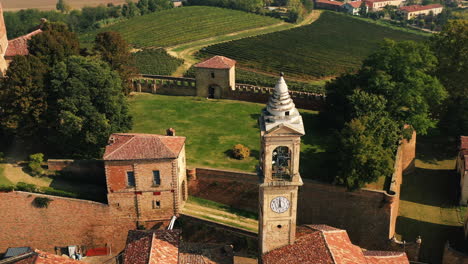 Aerial-view-circling-the-clock-tower-of-Montemagno,-in-sunny-Monferrato,-Italy