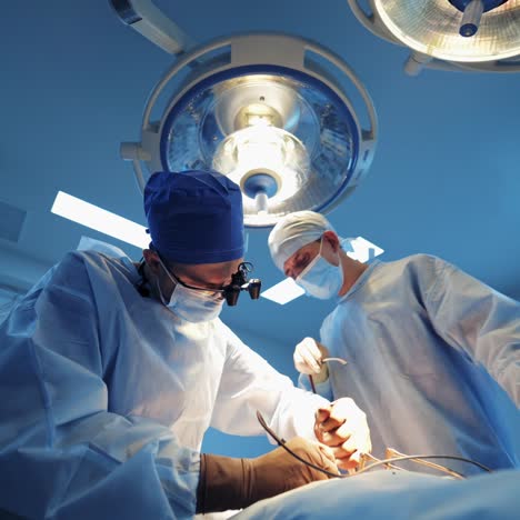 selective focus on neurosurgery operation process. woman nurse assistant in operating room. modern clinic interior