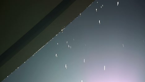 round drops of rain falling from edge