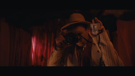 a man in hat takes a photo inside the circus cart