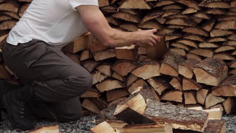 timelapse of man stacking firewood. - close up