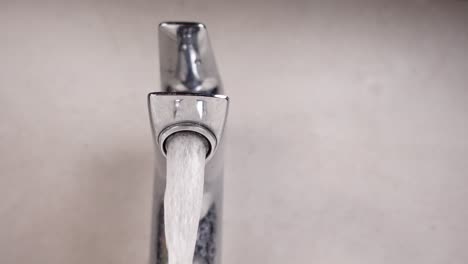 closeup of a faucet with water running