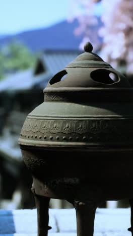 antique incense burner in a garden setting