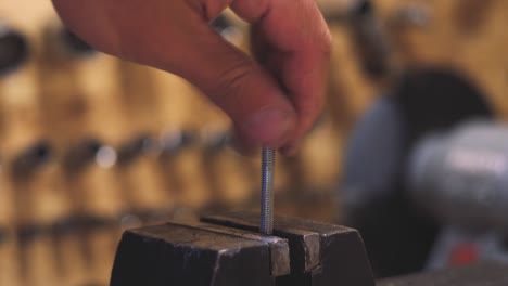 male hand screwing a nut onto a bolt