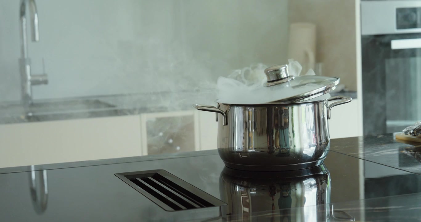 cooking pot producing heavy smoke on a kitchen stove, representing overheating, cooking accidents, fire hazards, smoke emergencies, and household safety risks.