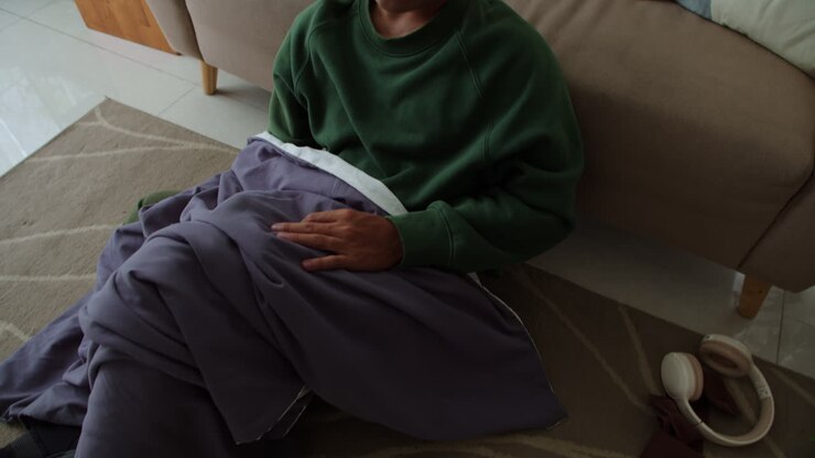 Sad man sitting on the carpet