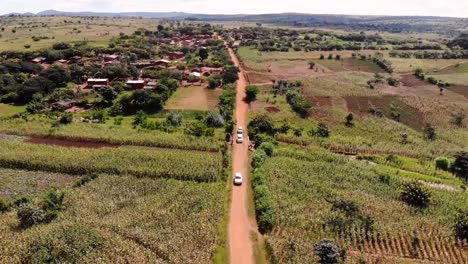 three cars driving on a dirt road in africa, journey across malawi