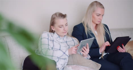 Businesswomen-Discussing-Over-Technologies-In-Office-Businesswomen-Working-On-Digital-Tablet-3