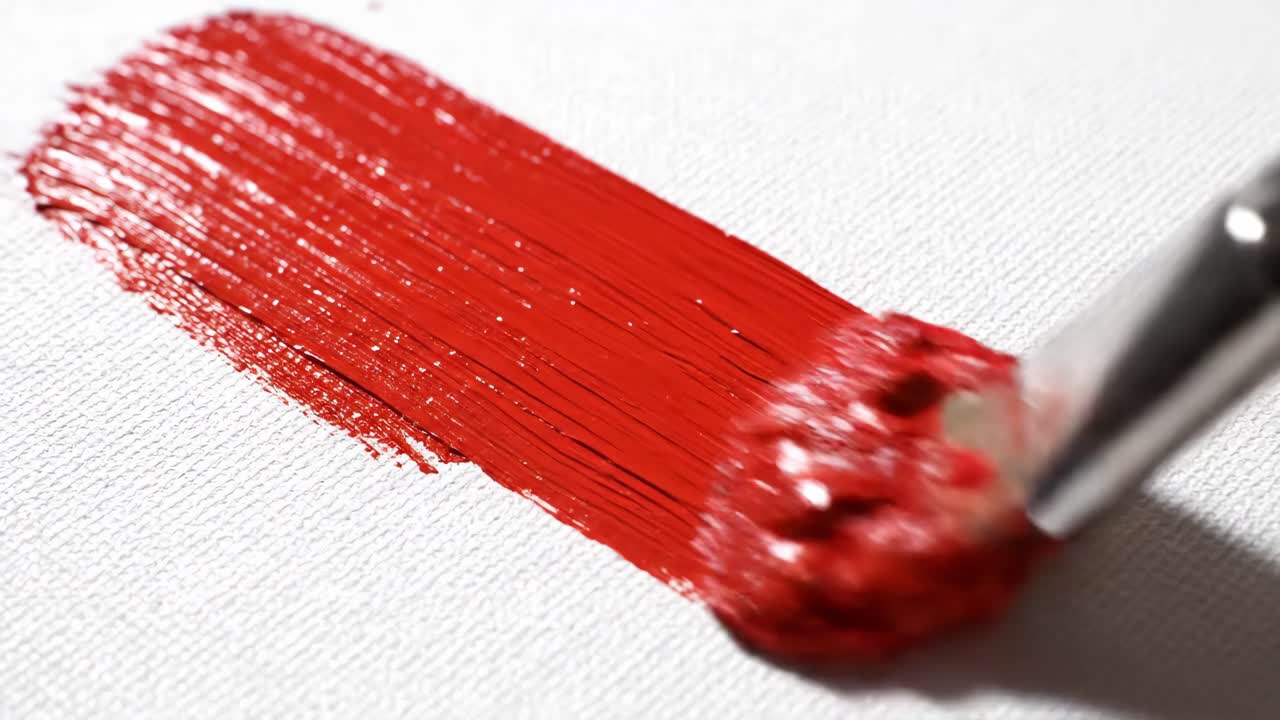 Close-up of Red Paint on Canvas with Brush