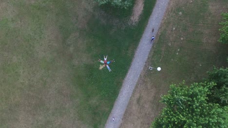 view from above of friends forming a star shape lying in grass