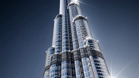 sunlight gleaming on burj khalifa, the tallest building in the world, located in dubai, united arab emirates, creating a stunning contrast against the dark blue sky
