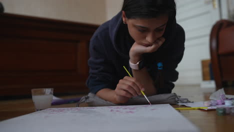 teenage girl painting at home
