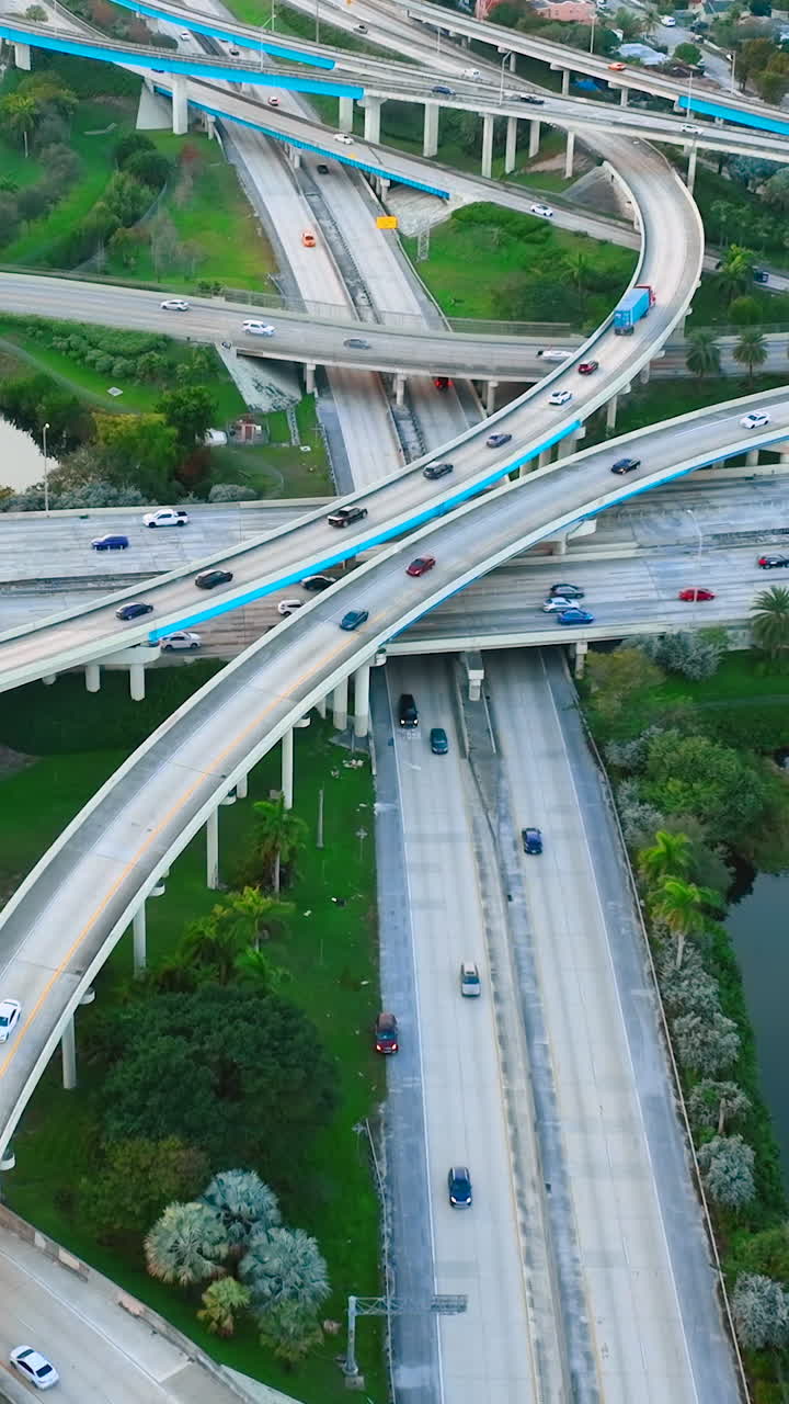 Aerial view of intersection of Interstate 95 and Florida State Route 112. Multilevel interchange with cars and road signs. Vertical video