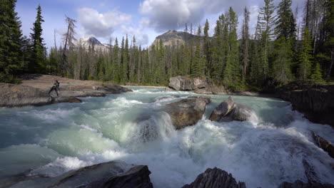 turquoise glacial rapids gushing down stream at yoho national park