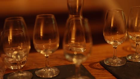 empty whiskey glasses on a wooden table