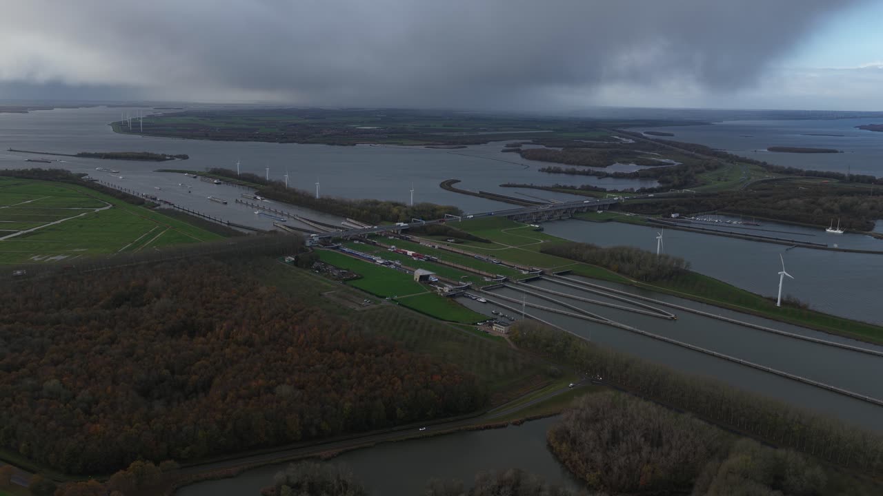 scale, engineering, and heavy commercial shipping activity at the Volkerak lock complex near Willemstad, a key link in the Scheldt–Rhine route. Aerial drone video