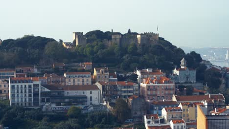 4K-Aerial-Shot-Of-Beautiful-Castle-of-Sao-Jorge-in-Lisbon-Downtown-near-Mouraria-At-Sunrise-Pan-Move