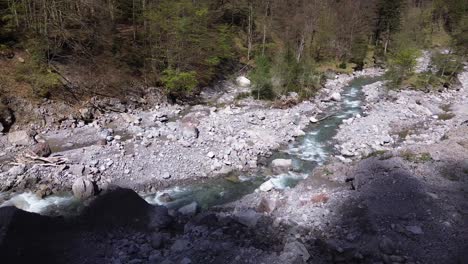 drone orbit above river in mountain valley in austria, europe