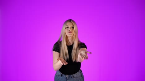 attractive blonde woman blowing kisses with hands gesture, studio portrait