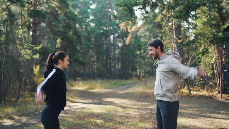 couple exercising outdoors in autumn park