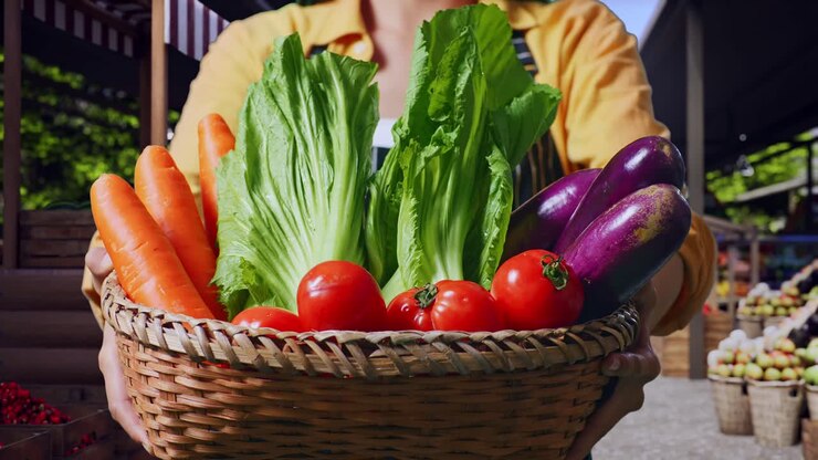 Close Up Of Asian Female Farmer Giving Basket With Vegetable At A Farmers Market
