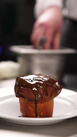 chef glazing a chocolate bun