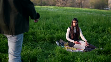 young couple playing cards in a park