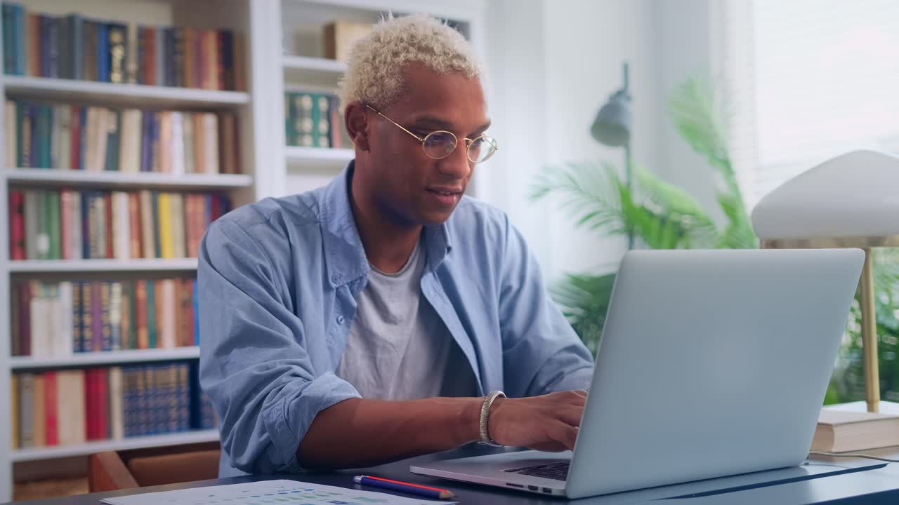 Ethnic african american man freelancer works with laptop in coworking offices